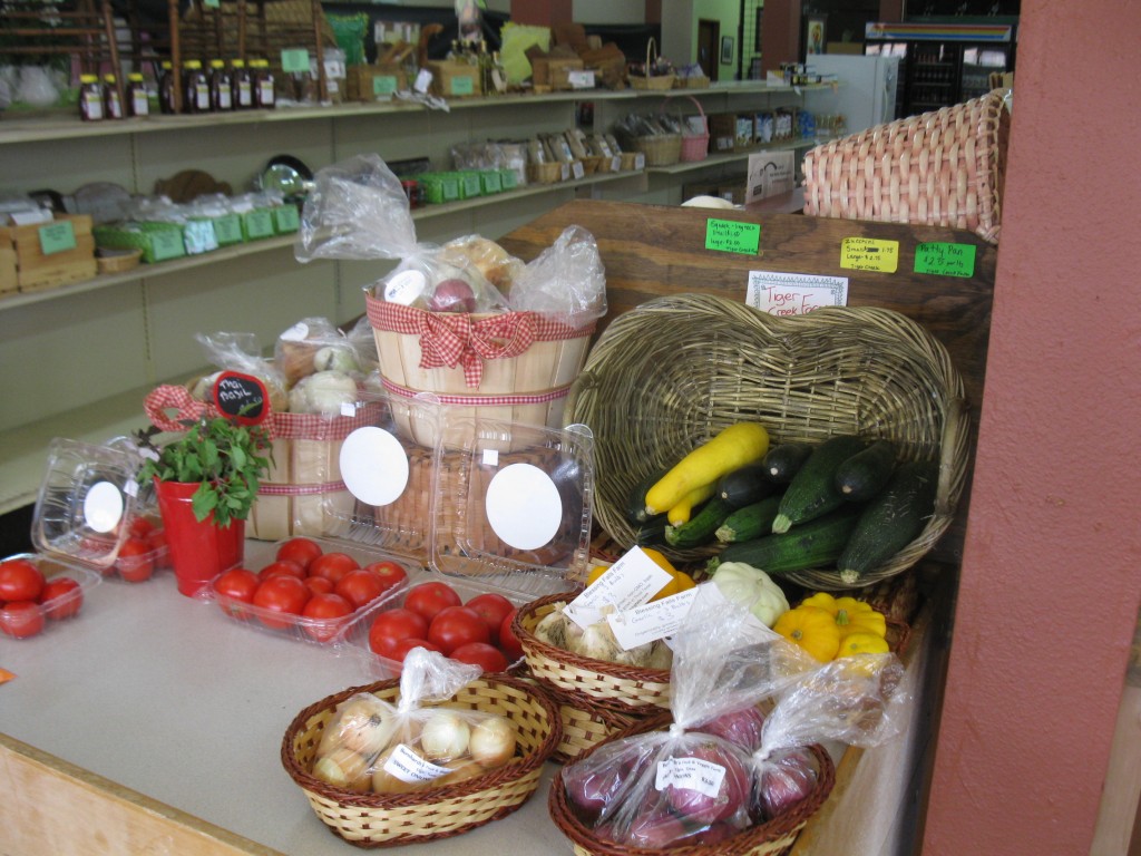 Produce from several farms greet you as you enter the store.  Our garlic is on this table.